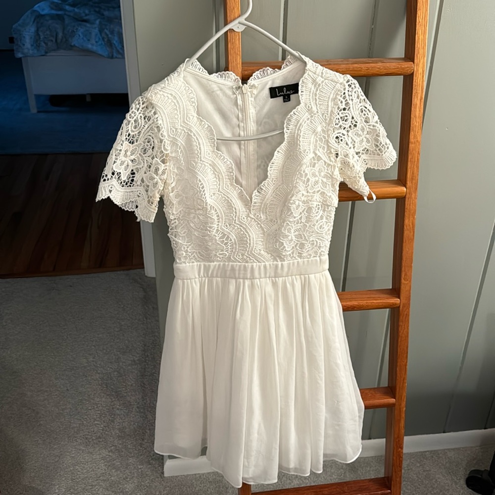 Lulus white lace dress. I am 5’7 and this hits right above my knees. Worn once